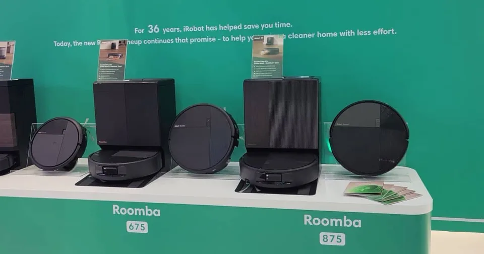 A robot floor cleaner sits beside its docking station while a hand points to components in a multi-panel product demonstration.