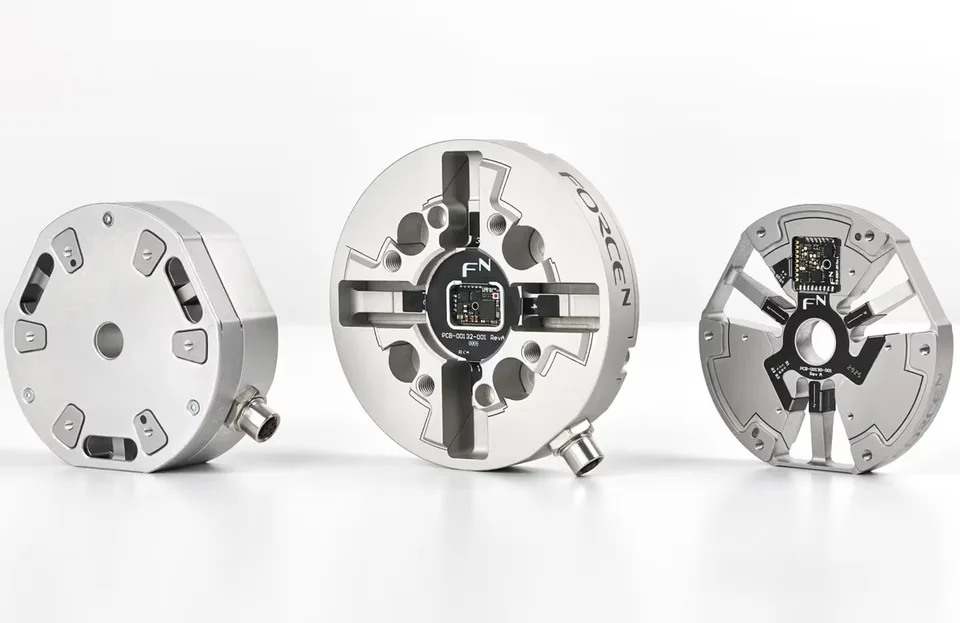 Three ForceN force-and-torque sensing components displayed side by side, alongside a RoboBusiness humanoid-robot event graphic.